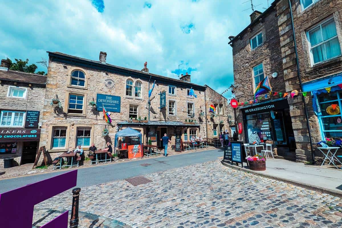 Attractive cobbled square with old stone pub called the Devonshire Arms in Grassington Yorkshire